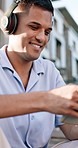 Outdoor, tablet and man with smile, headphones for audio and listening to music. Happiness, tech and person in city, chilling and digital app for live streaming, sound and playlist album for song