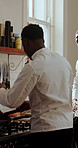 Black man, chef and discussion in kitchen for planning, advice or listen for restaurant training. People, mentor and team conversation with learning, culinary arts and cuisine with cooking and frying