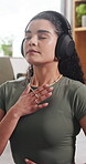 Mindfulness, home and woman with headphones for meditation, inner peace and calm with ambient sound. Breathing, person and healing mental health with music, zen and wellness on break in living room