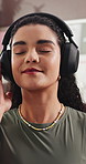 Smile, woman and relax with headphones at house for peace, streaming podcast and calm morning. Happy, female person and listening to music with eyes closed, playlist subscription and weekend break