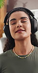 Peace, lounge and happy woman with headphones for meditation, zen or mindfulness with ambient sound. Calm, music and person with phone for song selection, mental health and wellness on break in house