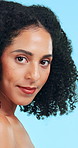 Face, shine and woman in studio, hair care and dermatology with texture on blue background. Volume, aesthetic and person with beauty, cosmetics and treatment for healthy skin, glow and grooming