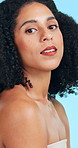 Face, wellness and woman in studio, skincare and dermatology on blue background. Texture, aesthetic and person with shine, beauty and treatment for healthy skin, glow and grooming with cosmetics