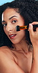Face, brush and woman in studio, makeup for shine and dermatology on blue background. Tools, facial foundation and person with aesthetic, glowing and product for beauty, skincare and cosmetics