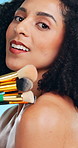 Face, brushes and woman in studio, makeup for skincare and dermatology on blue background. Tools, facial foundation and person with aesthetic, glowing and product for beauty, shine and cosmetics