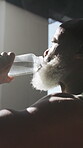 Fitness, drinking water or black man in gym with break, workout fatigue or hydration in intense practice. H2o, rest or mature person with bottle, training pause and recovery for performance goals.