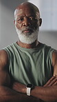 Fitness, face and black man with arms crossed at gym for bodybuilding, sport athlete or confidence. Bodybuilder, mature person or serious at health club for membership, muscle development or strength