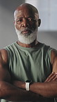 Strong, face and black man with arms crossed at gym for bodybuilding, sport athlete or confidence. Bodybuilder, mature person and serious at health club for membership, muscle development and fitness