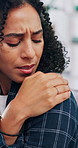 Woman, stress and shoulder pain in home with massage, medical problem or symptoms for fibromyalgia. Hurt, person and muscle inflammation in house with discomfort, health issue or injury from burnout.