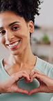 Face, heart hands and woman in home, fitness for health benefits and thank you. Apartment, gesture and happy person in lounge, smile and symbol for holistic care, kindness and motivation for training