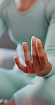 Yoga, hands and person with meditation in home, spiritual balance and body awareness practice for zen. Holistic, mindfulness and woman with lotus pose for inner peace, mental health and stress relief