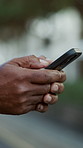 Phone, fitness and hands of man outdoor with texting, networking or communication on mobile app. Technology, sports and male person with cellphone for contact, email or social media in nature.