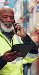 Tablet, phone call and black man in warehouse for shipping, logistics schedule or stock update. Tech, distribution or mature manager speaking to contact for inventory order or supply chain management