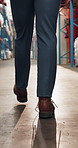 Person, legs and walking with inventory in warehouse for inspection, quality assurance or security. Back view, distributor or supplier in aisle for distribution, freight safety or storage in depot
