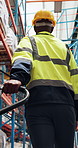 Logistics, walking or worker with trolley in warehouse, shipment import or export package for delivery. Pallet jack, supply chain or man with cargo transport for distribution, back or below in depot