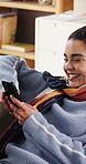 Woman, relax and laugh on sofa with phone, typing text message and funny joke for online dating app. Happy, person and scroll in home with tech, comedy video and meme response for social media chat.