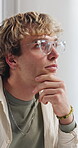 Creative, man and thinking in office with glasses, vision or graphic designer for marketing agency. Person, reflection or design idea in business with problem solving, plan or project for advertising