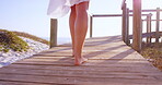 Walking, legs or woman on beach bridge for holiday, travel destination or summer break for adventure. Wind, feet and calm person with journey for weekend trip, outdoor and vacation in Australia