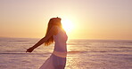 Ocean, sunset and freedom with woman at beach for summer vacation, tropical island and seaside. Holiday getaway, weekend break and peace with person outdoor for wellness, travel and paradise space