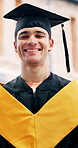 Face, graduation and man with smile on campus, academic success and pride for education milestone. Outdoor, portrait and student with happiness for college qualification, study achievement and laugh