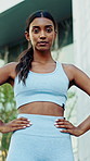 Serious, fitness and face of woman in city with confidence for runner, workout or training with health. Wellness, athlete and portrait of person with pride for sports, exercise or active in town.
