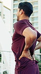 Fitness, hands and man in city with back pain, injury or accident for workout mistake. Health, athlete and male person in town with torn ligament, arthritis or fibromyalgia for outdoor exercise.