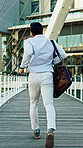Businessman, rush or running with bag for late schedule, busy work or urgent deadline in city. Back view, male person or employee with speed or hurry on bridge for commute or delay in an urban town