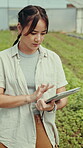 Farming, woman and tablet for crops inspection with online checklist, progress and growth of plants. Greenhouse, agriculture and tech with asian person happy with app, development or quality control