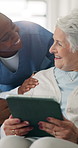 Caregiver, talk and old woman with tablet in nursing home, healthcare and check medication schedule. Happy, nurse and elderly person with tech for health update, learning and senior care in house