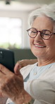 Smile, old woman and relax with phone at house for social media, browsing website and download ebook. Happy, senior person and laugh with mobile for comedy video, reading meme and retirement break