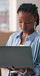 Logistics, online and women with laptop in small business, serious or planning for shipment delivery. Shipping, entrepreneur and black person with tech for inventory, schedule and check sales on web