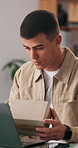 Man, reading and boxes with laptop at house for logistics, supply chain and ecommerce delivery. Male person, package and pc for online order, inventory management and pricing parcel for distribution