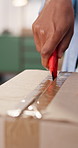Person, hands and cutting with box for logistics, delivery or unpacking cargo in home. Supply chain, knife and breaking package seal with tape on parcel for unboxing, courier service or distribution