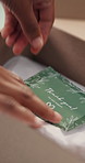 Person, hands and box with thank you label for small business, logistics or delivery. Closeup, distributor or supplier with message or note in package or parcel for courier service or appreciation