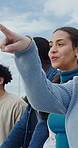 Friends, smile and talk with point at park for bonding, connection and reunion in urban town. Happy people, gen z group and sightseeing with discussion, solidarity and outdoor with diversity in city