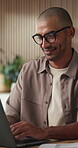 Happy man, typing and creative with laptop in office, online and scriptwriter with glasses for story. Screenplay, research and person with smile for draft, publication and media project on website