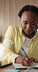 Woman, writing and notebook in office with laptop, reading and research idea for digital marketing. Black person, typing and taking notes in business with computer, journal and plan for advertising.
