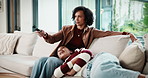 Mother, child and watching tv in home with remote, bonding together or conversation for film choice. Happy, mom and daughter talk on sofa for streaming show, change channel or relax for entertainment