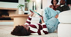 Family, relax and child on tablet in living room for movies, streaming or internet show for bonding. Parents, girl and digital tech for social media, play and mobile app in home for weekend together