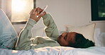 Relax, child and scroll with phone on bed for social media, browse online platform or web addiction. Isolation, kid and mobile in home for streaming subscription, internet dependence or app download