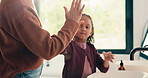 High five, hair care and parent with child in bathroom, grooming routine and support for wellness. Morning cleaning, towel and mother with happy girl for getting ready, hairstyle and bonding in home