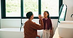 High five, hair care or mother with child in bathroom, grooming routine or support for getting ready. Morning motivation, happy or woman with girl by mirror for wellness, hairstyle or bonding in home
