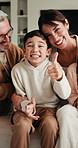Happy, thumbs up and face of family on sofa in home with bonding, love and connection together. Smile, relax and portrait of parents with children for support, care and safety in living room at house
