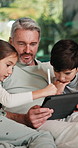 Tablet, pen and father with children on sofa in home for educational game on app for bonding. Happy, family and dad with kids for online gaming together on digital technology in living room at house.