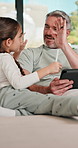 Tablet, high five and father with child on sofa in home for educational game on app for bonding. Happy, pen and dad with kid for online gaming together on digital technology in living room at house.