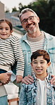 Children, home and face with happy family for love, real estate or outdoor bonding together. Portrait, mom and dad with kids, siblings or smile for childhood, protection or safety in house backyard