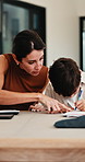 Mother, helping and child with notebook at house for education, studying and exam preparation. Parent, guidance and kid writing for learning, school homework and quiz assignment for knowledge in home