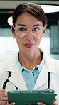 Doctor, face and woman with tablet in medical career, happy or confident in hospital hallway. Smile, portrait and mature physician with digital tech for healthcare service, planning or job excellence