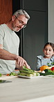 Dad, vegetables and cooking with kid in kitchen for meal prep, healthy diet or lunch. Father, child or teaching daughter with natural organic ingredients for culinary lesson or hospitality in home
