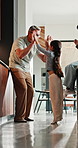 Parents, child and happy with high five in home for growth milestone, family bonding or support. Mature people, girl kid and celebration in house for development praise, healthy relationship or laugh
